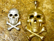 Large skull in 14kt yellow, small in sterling silver